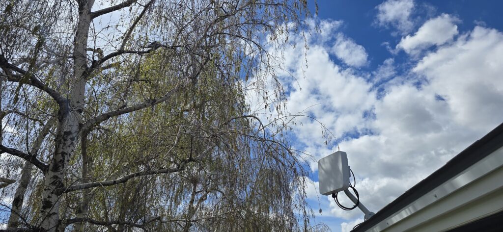 Advanced Internet Air Fiber dish on a customers roofline